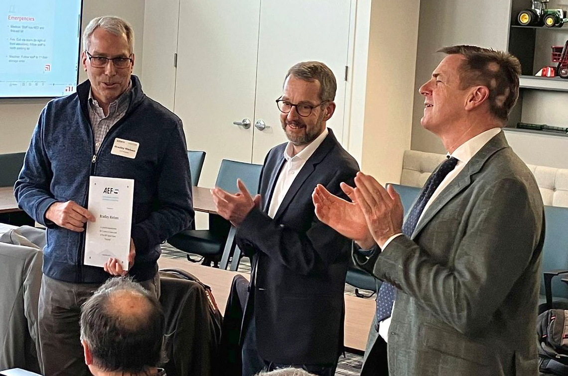 Bradley Nielsen got a present for his dedicated work and Team Lead for “Security” from General Manager Norbert Schlingmann and Andrew Olliver, AEF Chairman.  